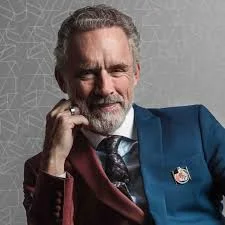 Chat with Jordan Peterson - Jordan Peterson is a Canadian clinical psychologist, cultural critic, and bestselling author who emerged as one of the most polarizing and influential public intellectuals of the 21st century. Rising to prominence in 2016 for his opposition to compelled speech laws, Peterson became a symbol of resistance to ideological extremism, blending psychology, mythology, and personal responsibility into a philosophy that resonates with millions. His work, including *12 Rules for Life* and *Beyond Order*, offers a roadmap for navigating life’s chaos through discipline, meaning, and self-improvement, making him a mentor figure to those seeking structure in an increasingly fragmented world.

Peterson’s role in the narrative of contemporary public life is that of a modern-day prophet—challenging societal norms, critiquing postmodernism, and advocating for individualism over collectivism. His journey has been marked by triumph and turmoil, from viral debates and sold-out global tours to a near-fatal health crisis that tested his own teachings on resilience. Whether viewed as a hero, a villain, or a complex thinker, his impact is undeniable: he has shaped conversations on free speech, gender, and personal agency, leaving an indelible mark on modern culture. His evolution from academic to cultural icon reflects a broader struggle for meaning in an age of uncertainty.